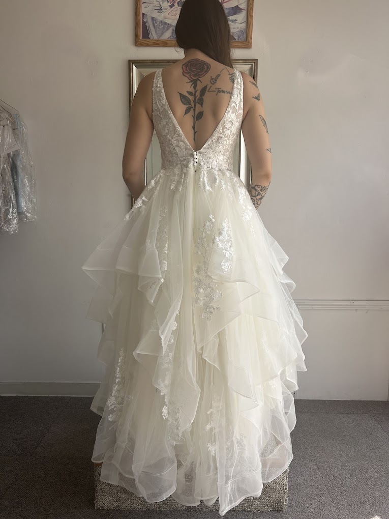 Back view of an altered lace and tulle wedding dress showing the finished fit