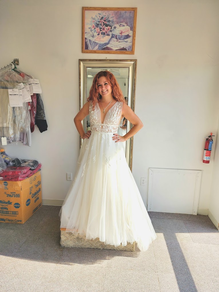 Customer smiling in a fitted wedding gown at Rosa Alteration & Tailor